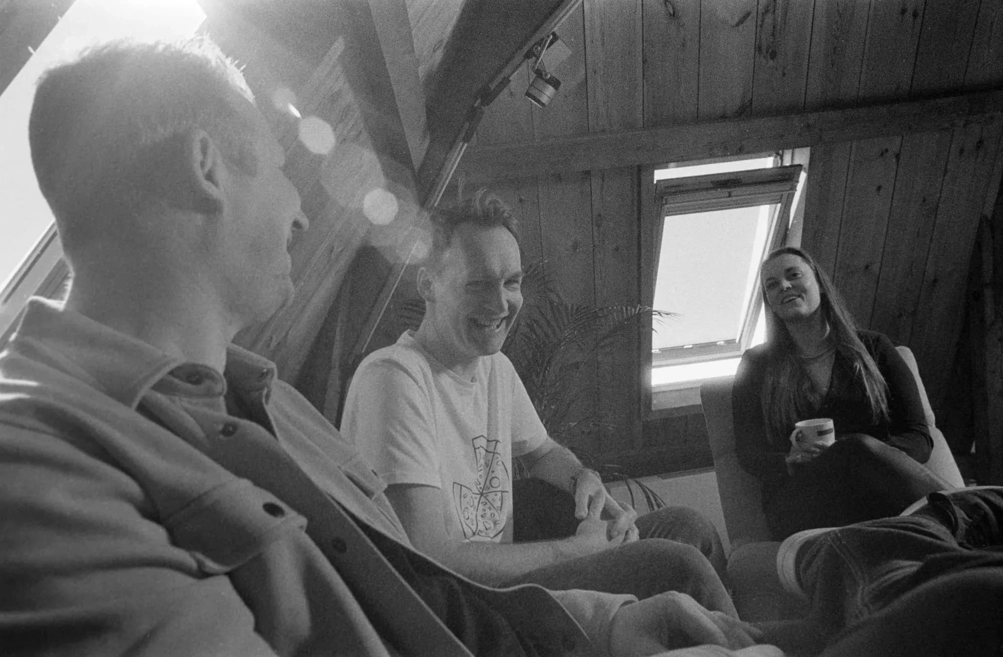Three colleagues in meeting, smiling at eachother