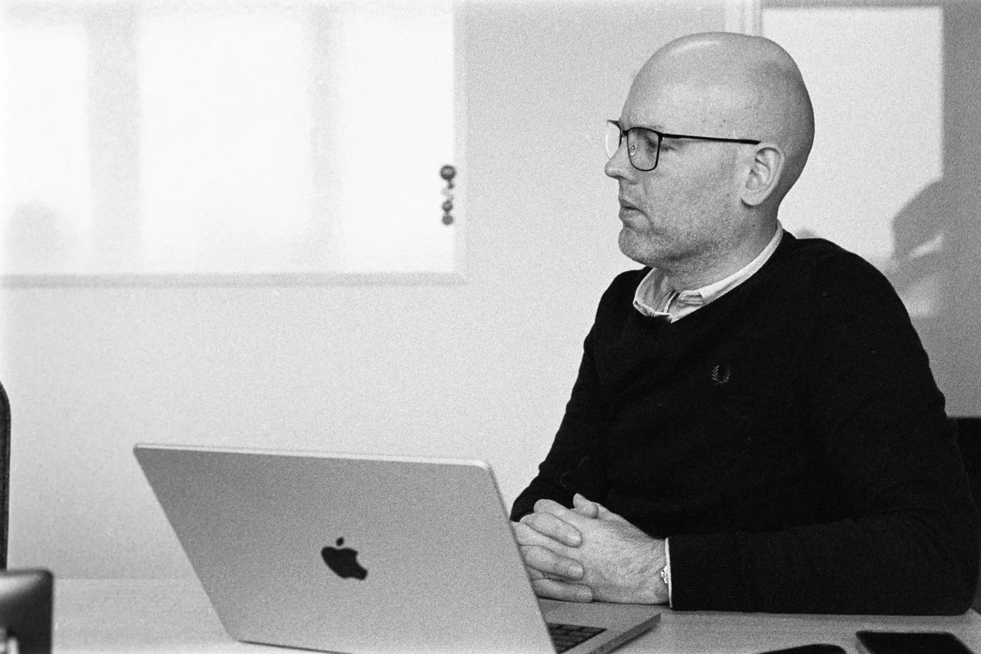 Colleague behind his laptop, at meeting