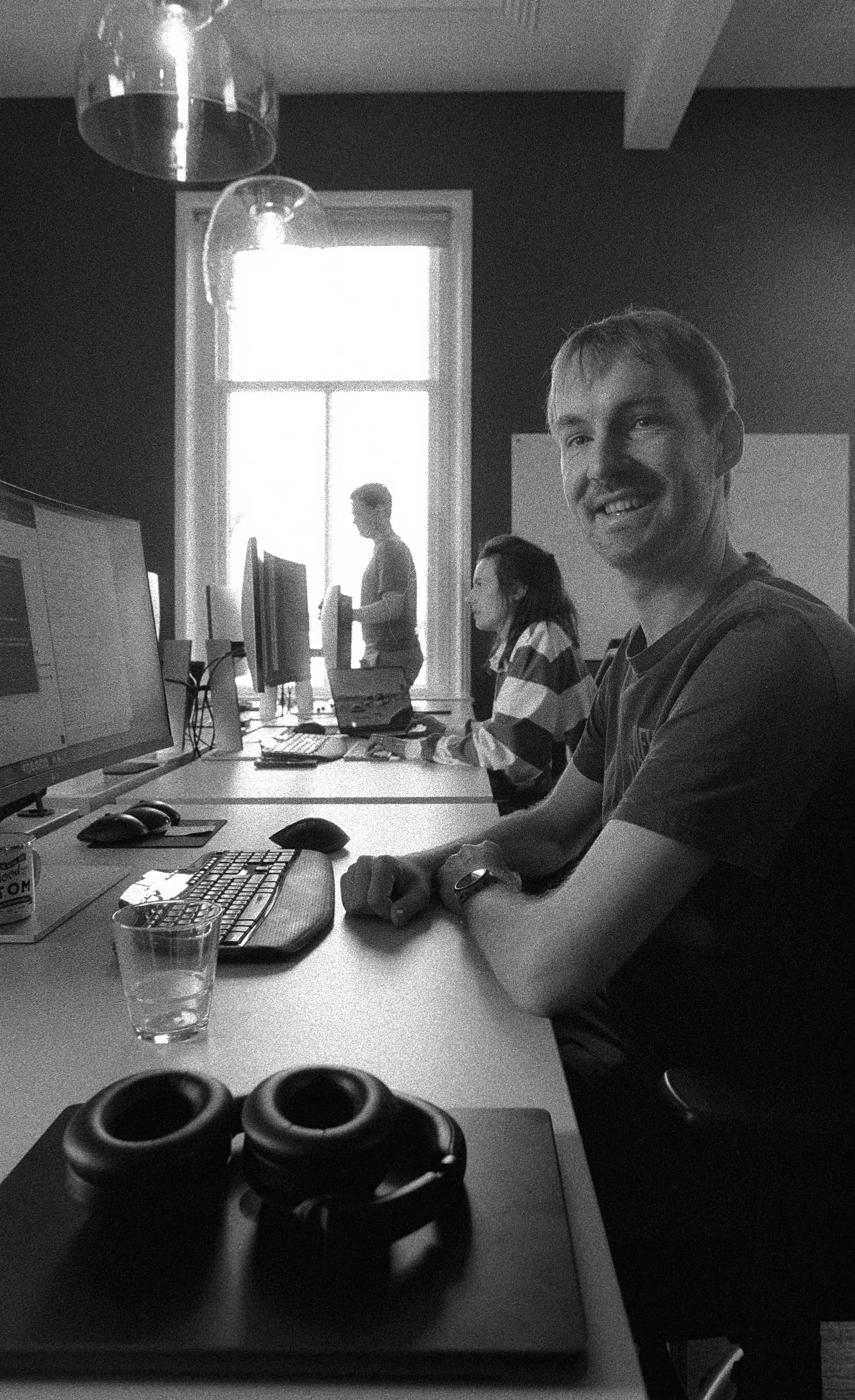 Colleagues at office, smiling at camera
